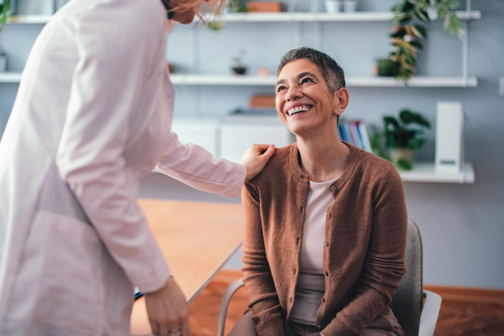 Doctor reassuring patient in bright clinic interior during consultation