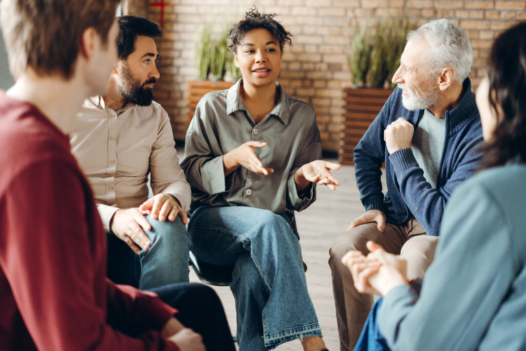 Group of people sitting in a circle talking