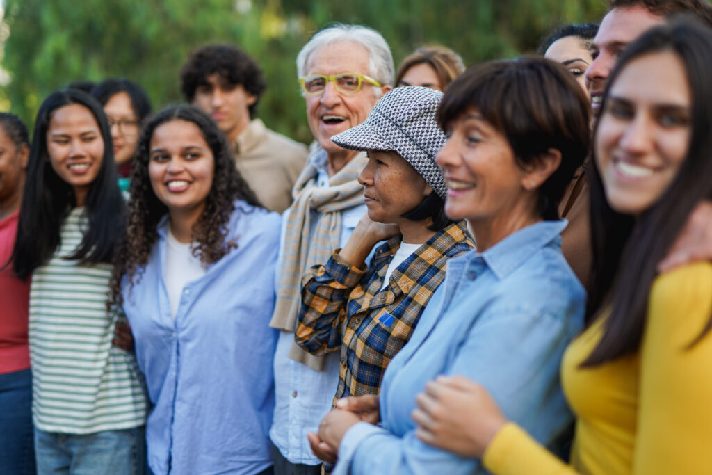 Group of people of varying ages connecting and meeting up at a park